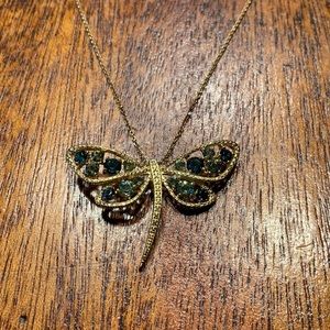 Gold dragonfly necklace with green accent stones